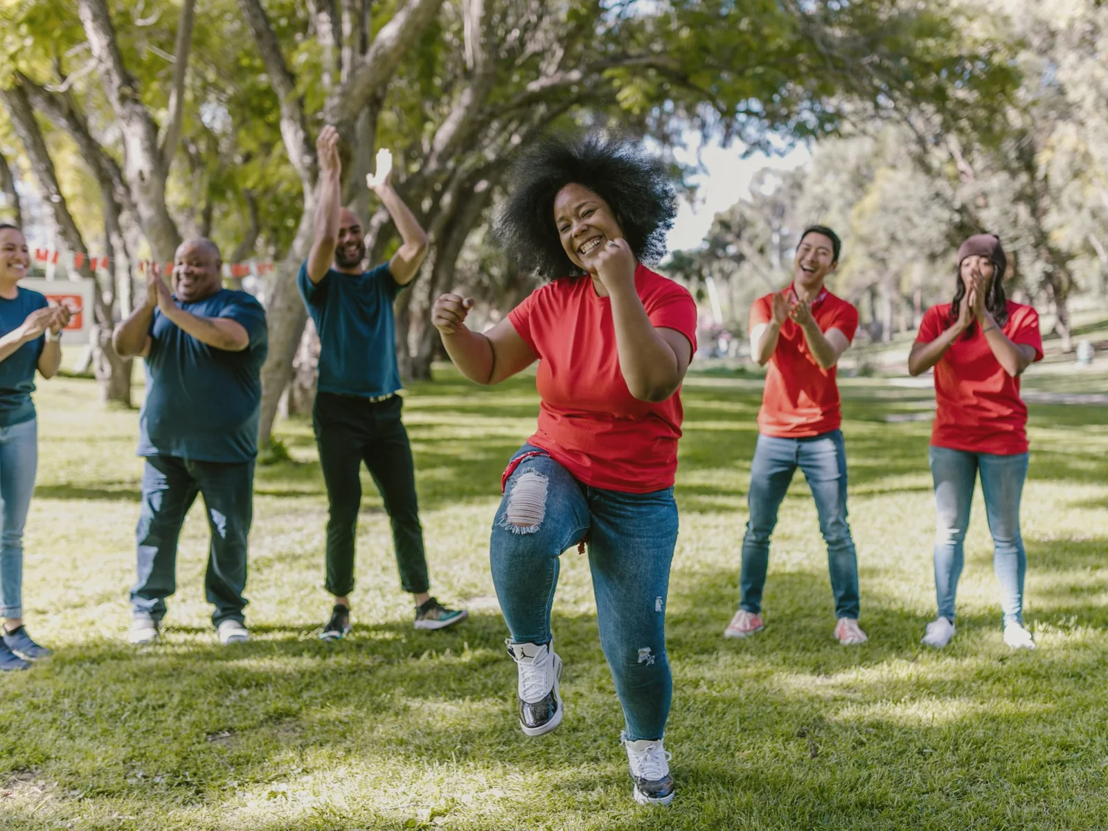 A diverse group of adults taking part in an outdoor activity